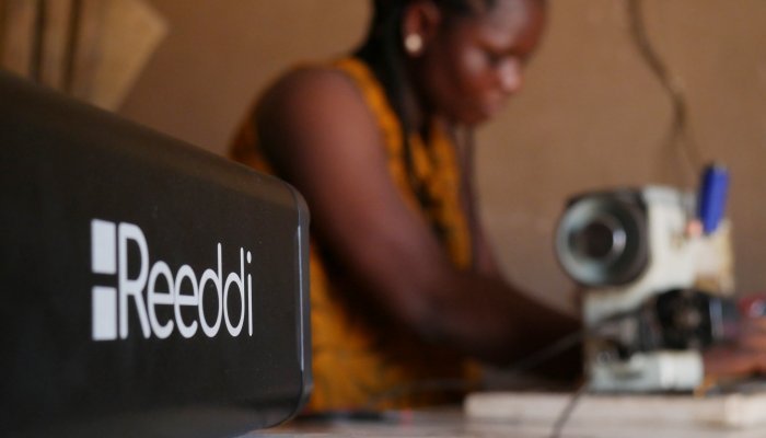 A tailor uses the Reeddi Capsule to power her electricity-powered sewing machine. Photo: Reeddi